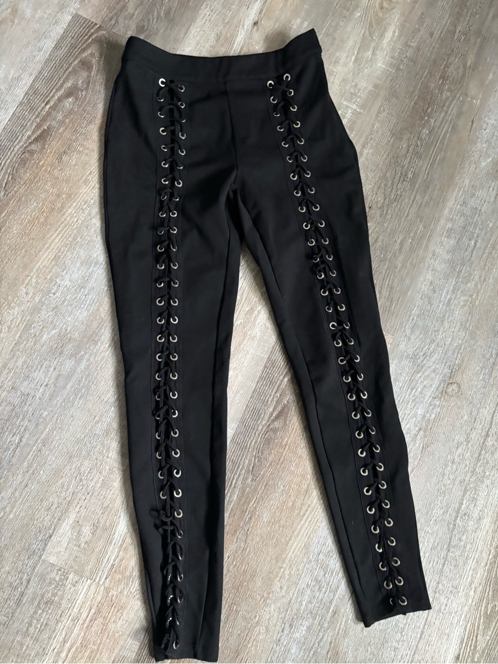 Black stretchy pants with grommets and ties up the front